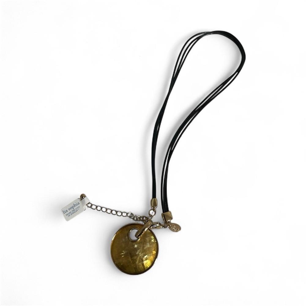 Lia Sophia Taos necklace with a gold-toned, round, shell-mosaic pendant on brown